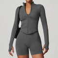 Dark gray long sleeved sports set with standing collar long zippered top and biker shorts