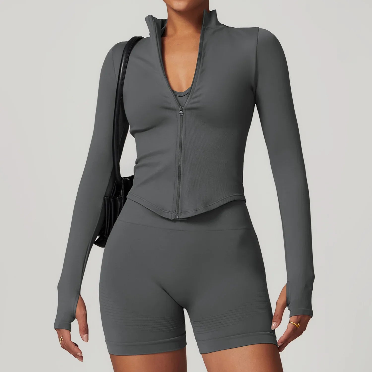 Dark gray long sleeved sports set with standing collar long zippered top and biker shorts