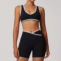 Black sports bra and biker shorts set with white trim from Blue-Grey Workout Outfit Fitness Sportswear