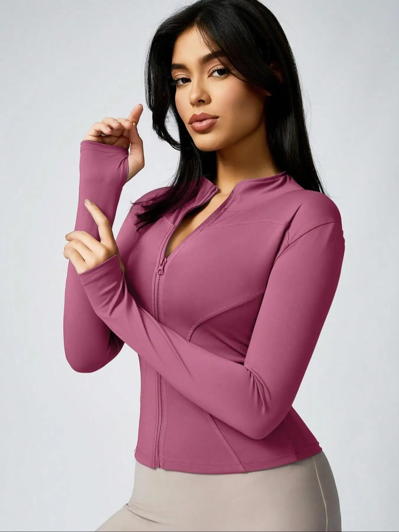 Brown cropped athletic jacket with mauve long-sleeve zip-up top