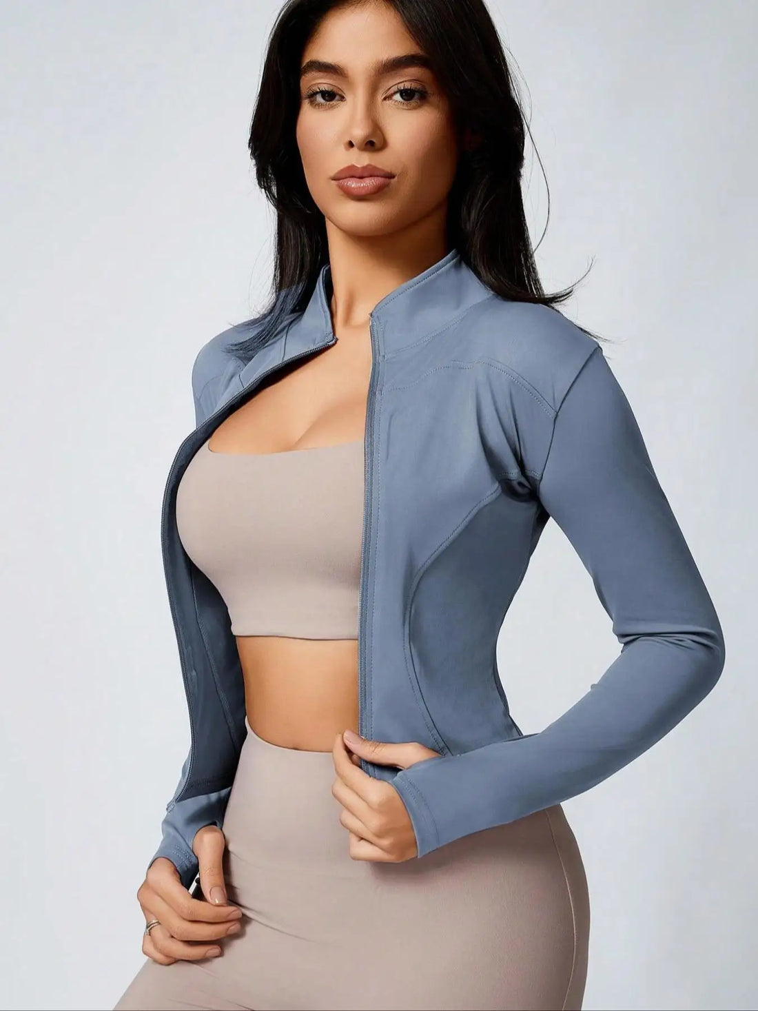 Brown cropped athletic jacket with beige sports bra and biker shorts set