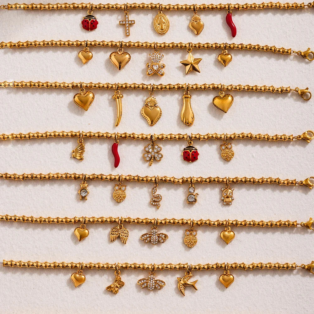 Gold charm bracelets with cubic zircon geometric pendants and various charms