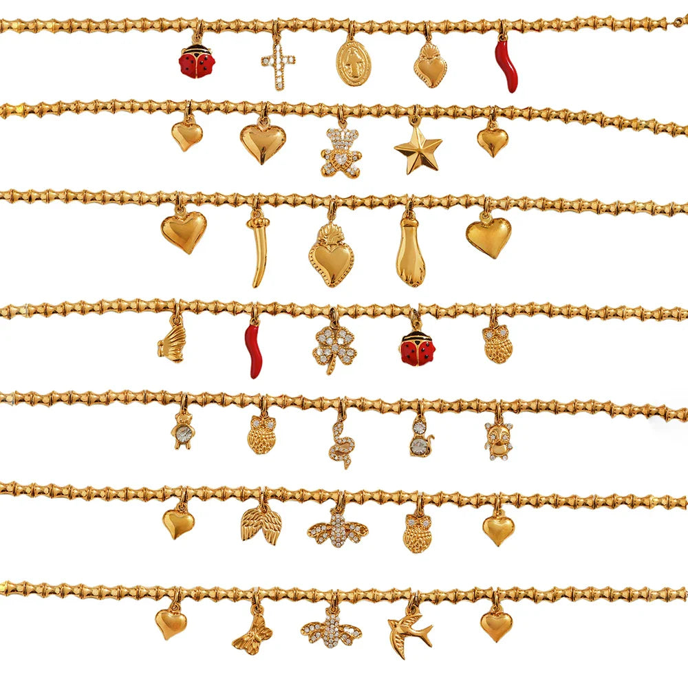 Multiple rows of gold charm bracelets with cubic zircon geometric pendants and charms