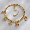 Gold-toned charm bracelet with marine animal and heart charms, featuring cubic zircon geometric pendant