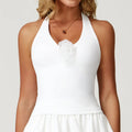 Woman wearing a white halter-neck shockproof yoga vest with ruffles and fabric flower detail