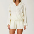 Off-white hooded windbreaker and matching shorts set for outdoor sports women