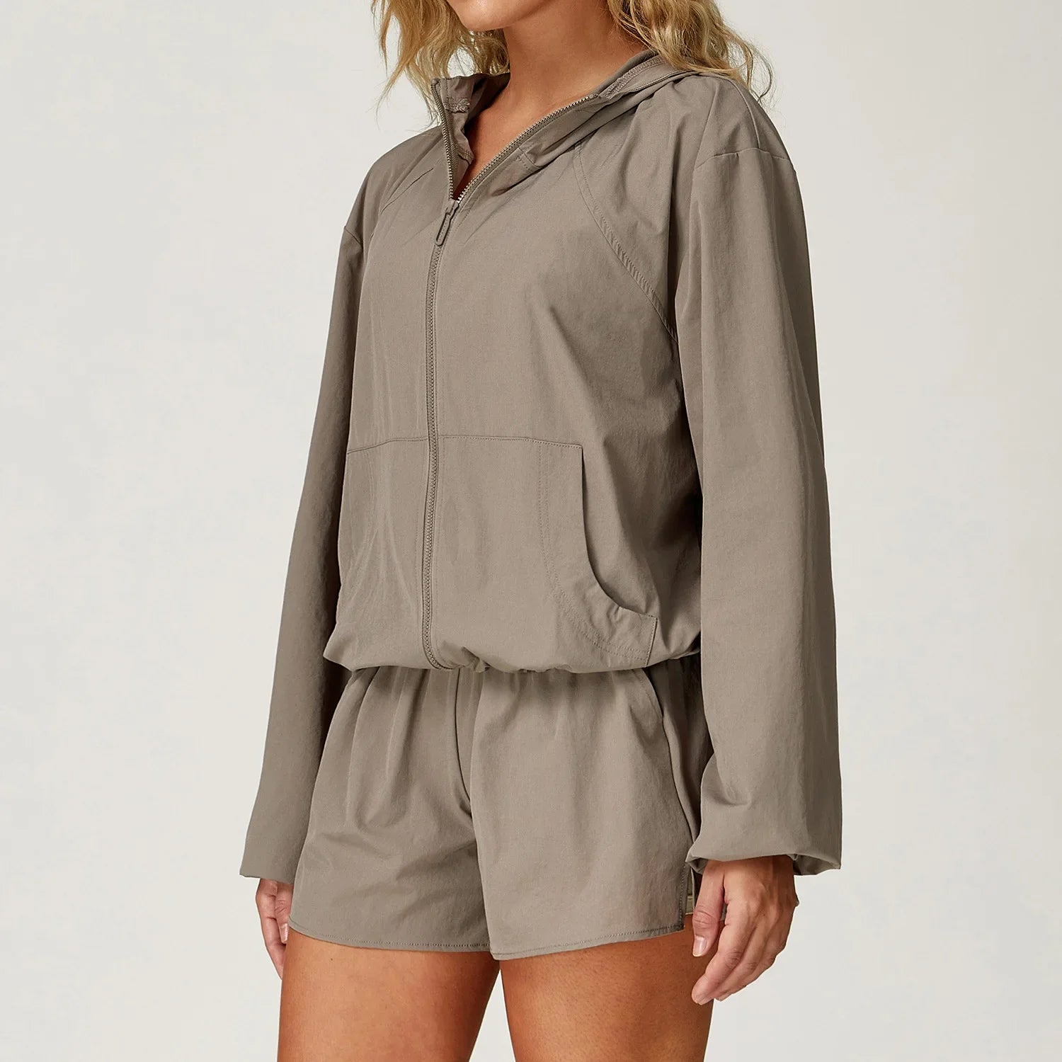 Taupe-colored athletic windbreaker and matching shorts set for outdoor sports women