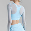 Light blue solid color mesh sports top with V neck and short sleeves over a light blue sports bra