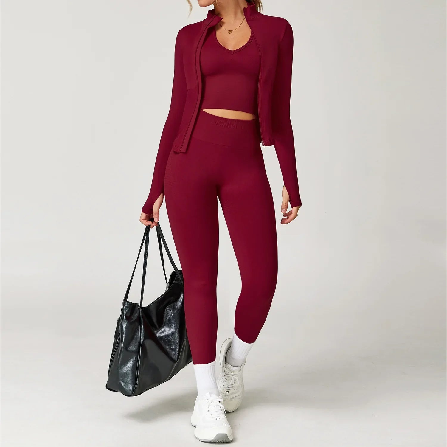 Woman in light pink seamless gym set with jacket, bra, and leggings