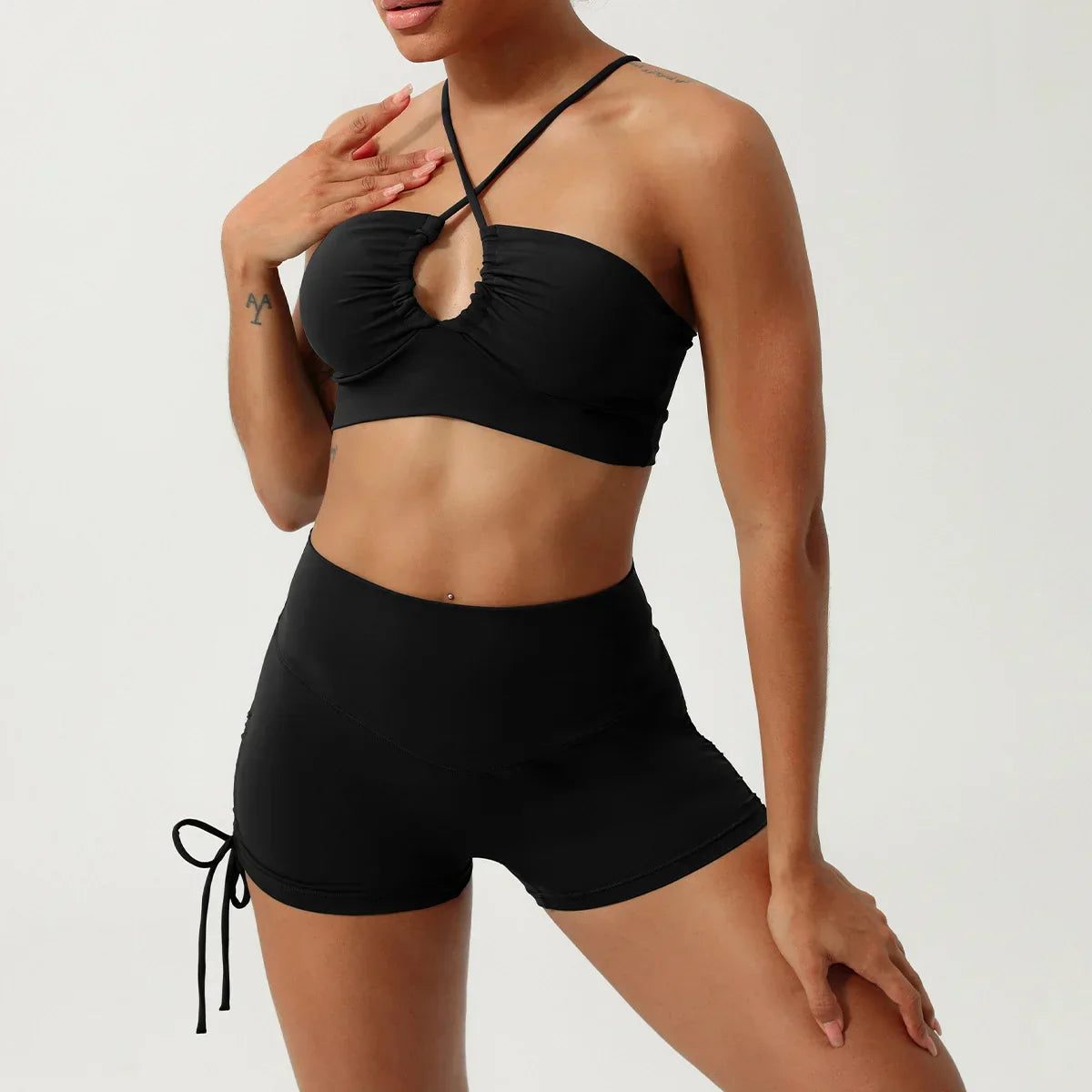 Rust halter neck yoga set with black high-waisted ruched shorts