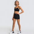 Woman in black 2pcs yoga set gym suits with white athletic shoes