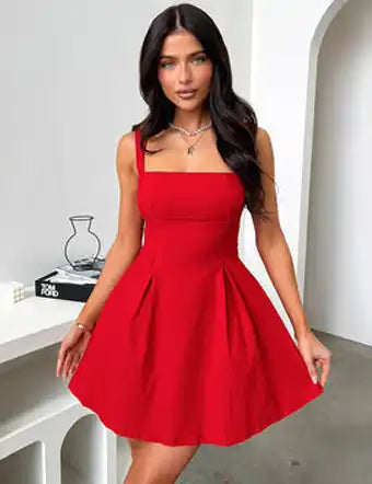 A woman in a vibrant red mini dress with a square neckline and a pleated A-line skirt.